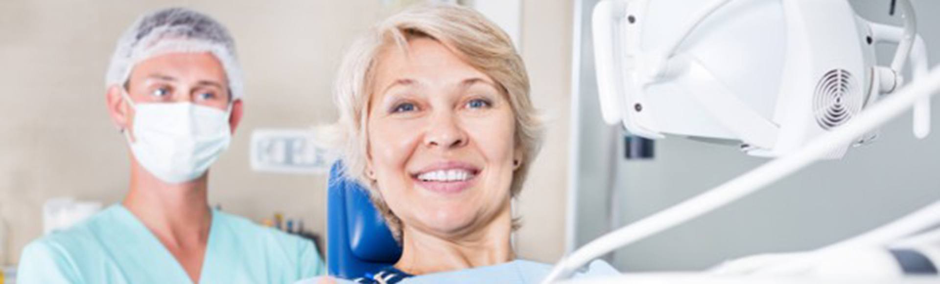 Happy dental patient making thumbs up gesture