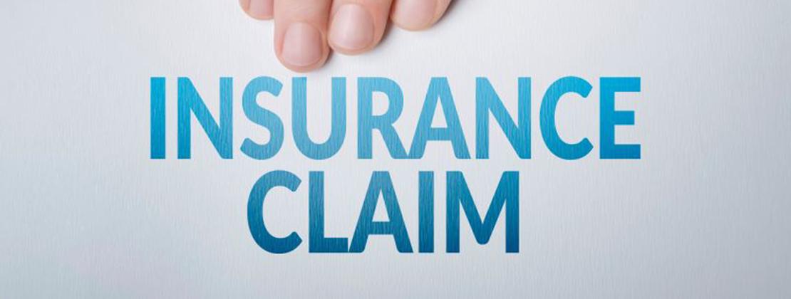 Hand holding insurance claim document
