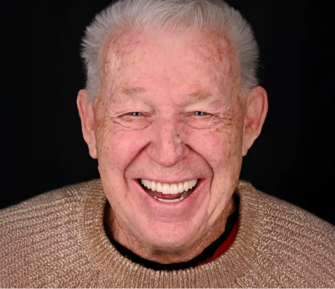 Smiling senior man in a light brown sweater