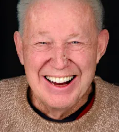 Smiling senior man in a light brown sweater