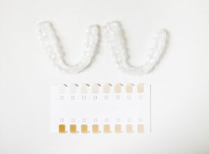 Teeth whitening trays next to dental shade guide