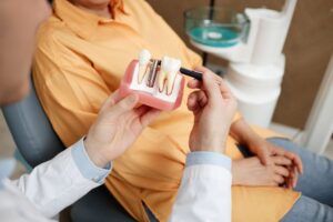 Dentist and patient talking during dental implant consultation